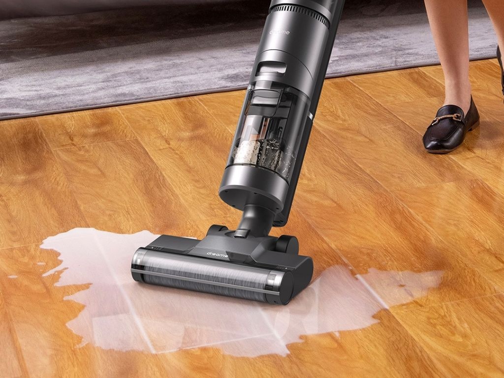 User cleaning living room carpet with a dry vacuum cleaner Lagos Nigeria