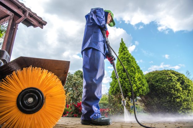 Technician inspecting pressure washer hose for cracks before use Lagos Nigeria