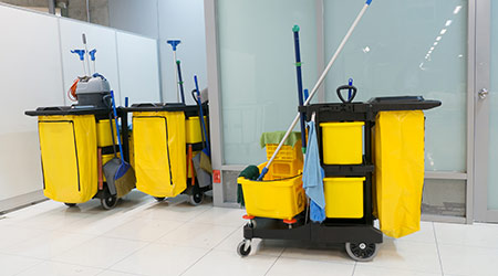 Full-size janitorial trolley with cleaning tools and waste bin used in commercial cleaning Lagos Nigeria